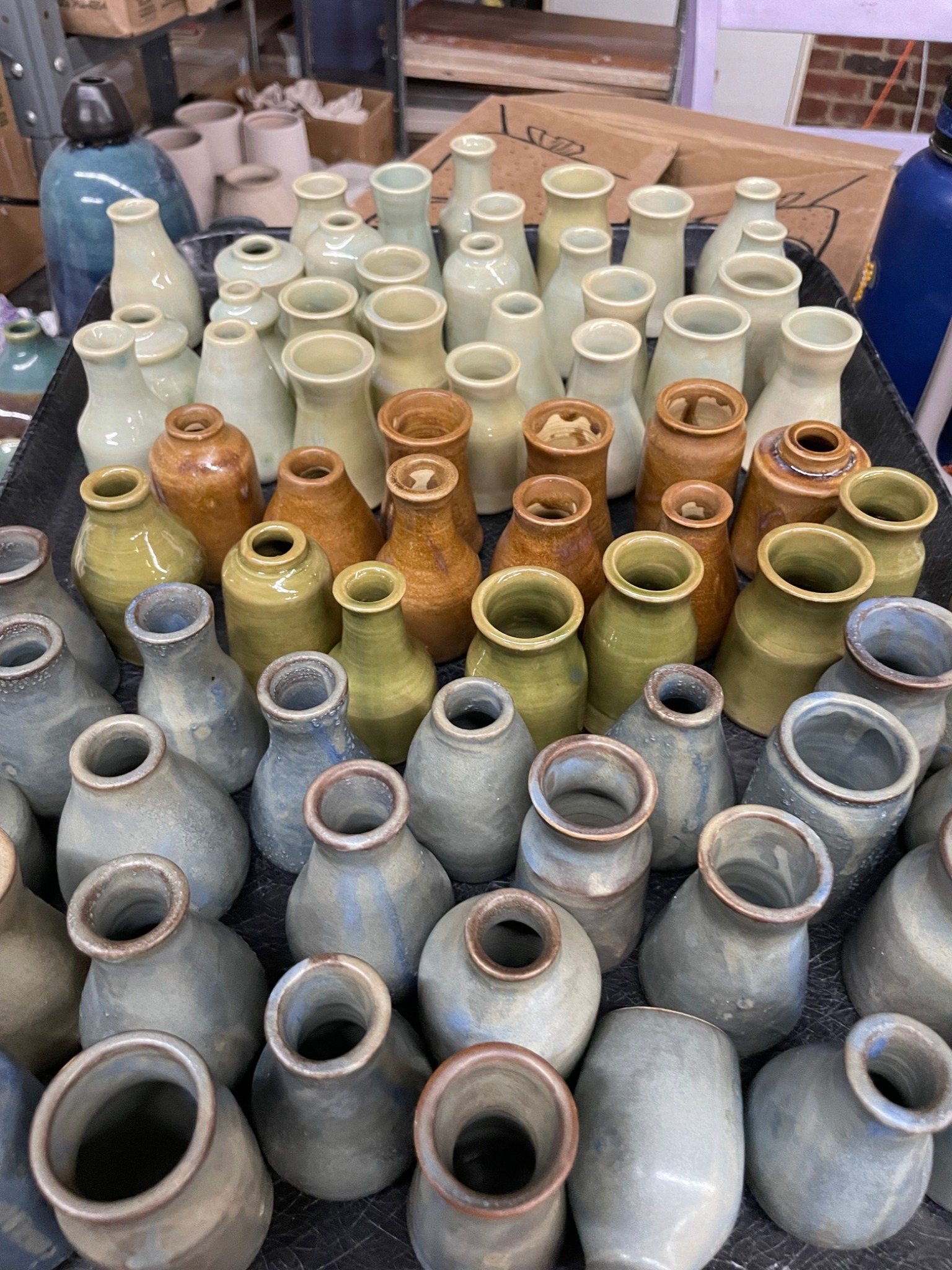 Handmade lidded ceramic jars in raw clay