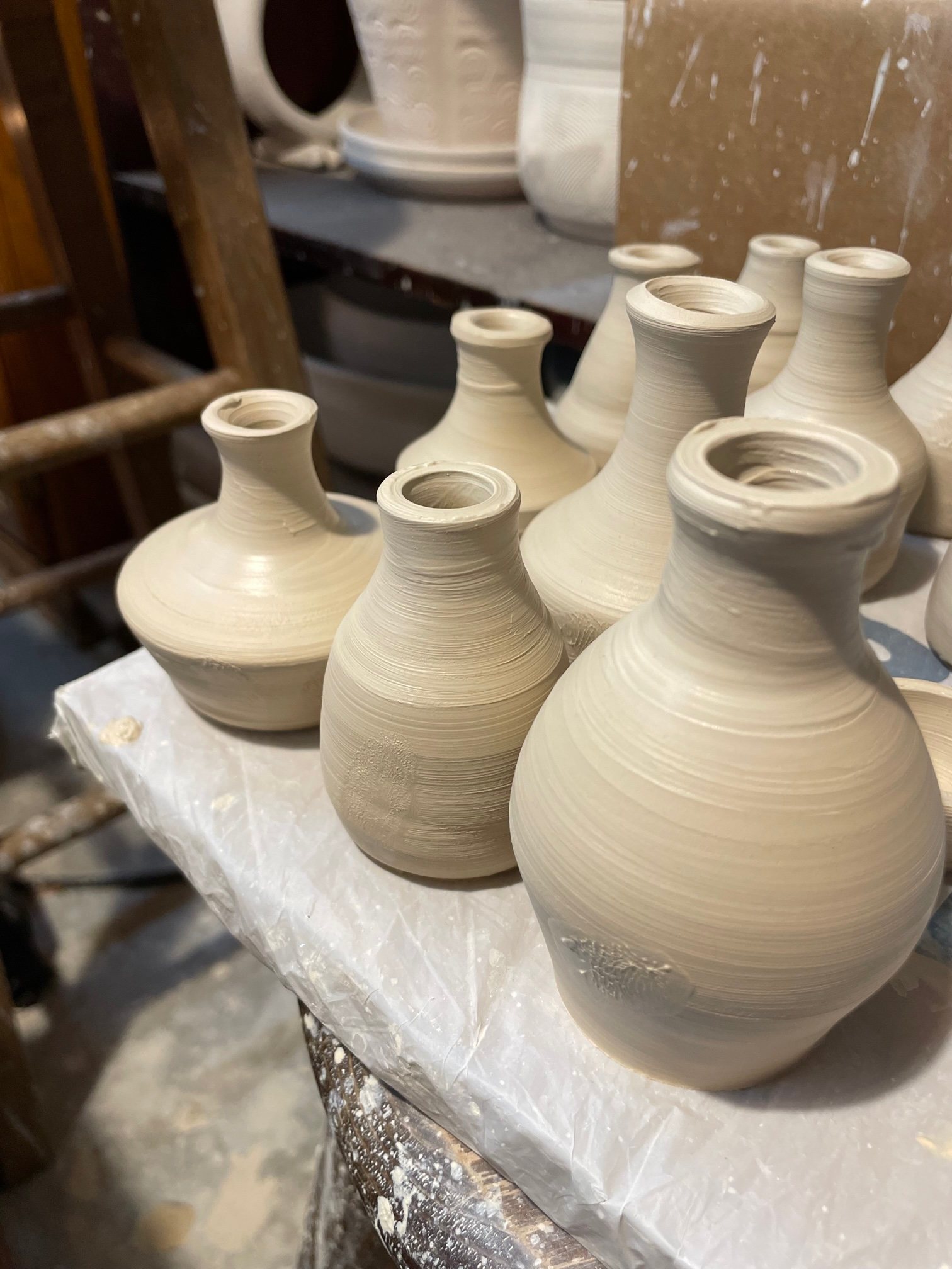 Freshly thrown wet clay bottles