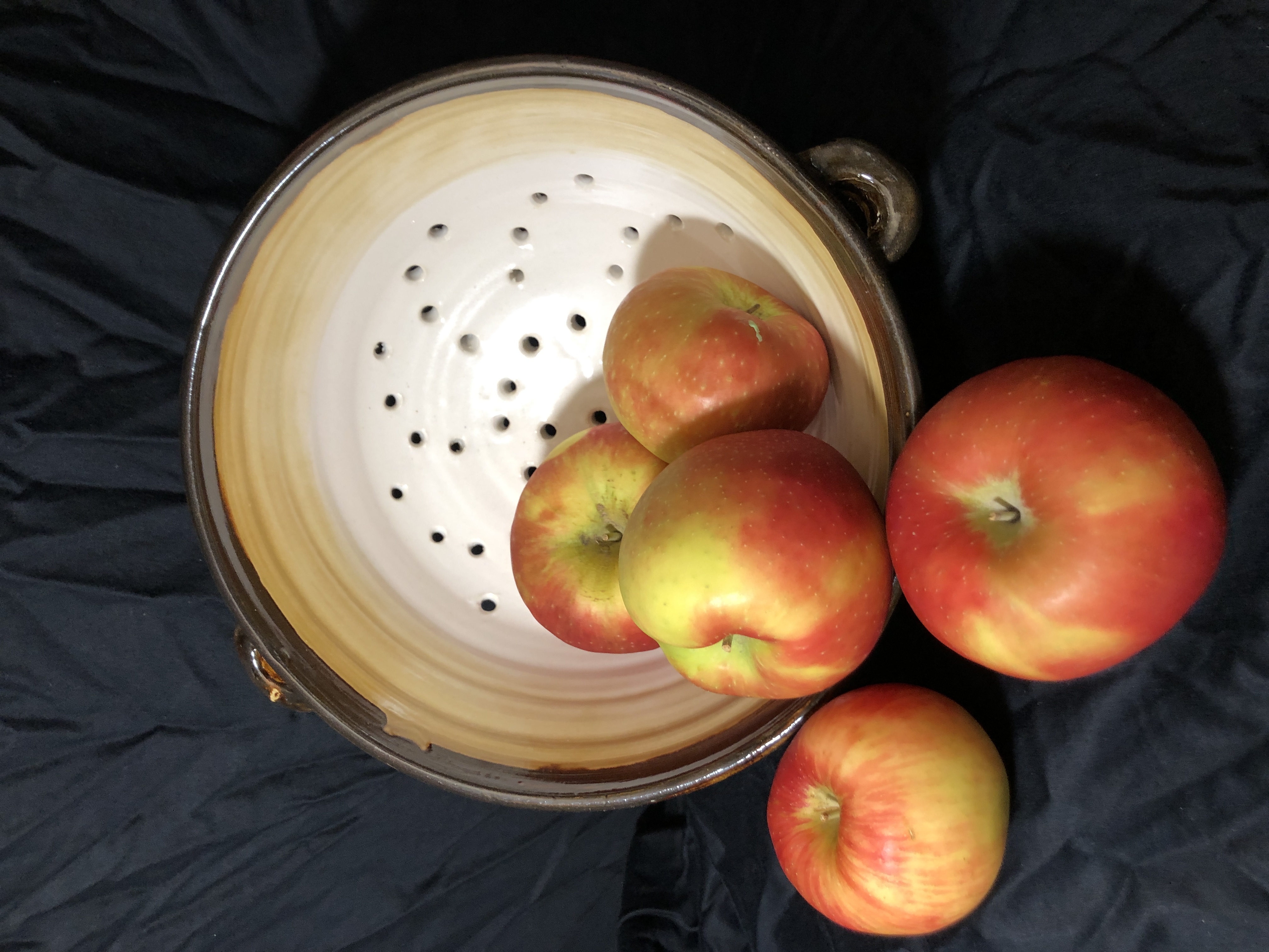 Ceramic strainer bowl with apples